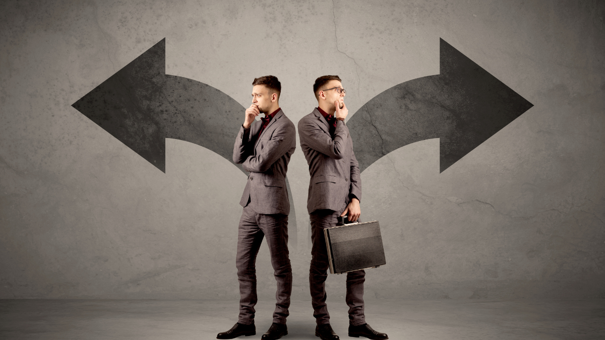 A businessman standing at a fork in the road facing multiple directions, representing the sales inconsistency that results from lacking ideal customer profile clarity and a defined market focus